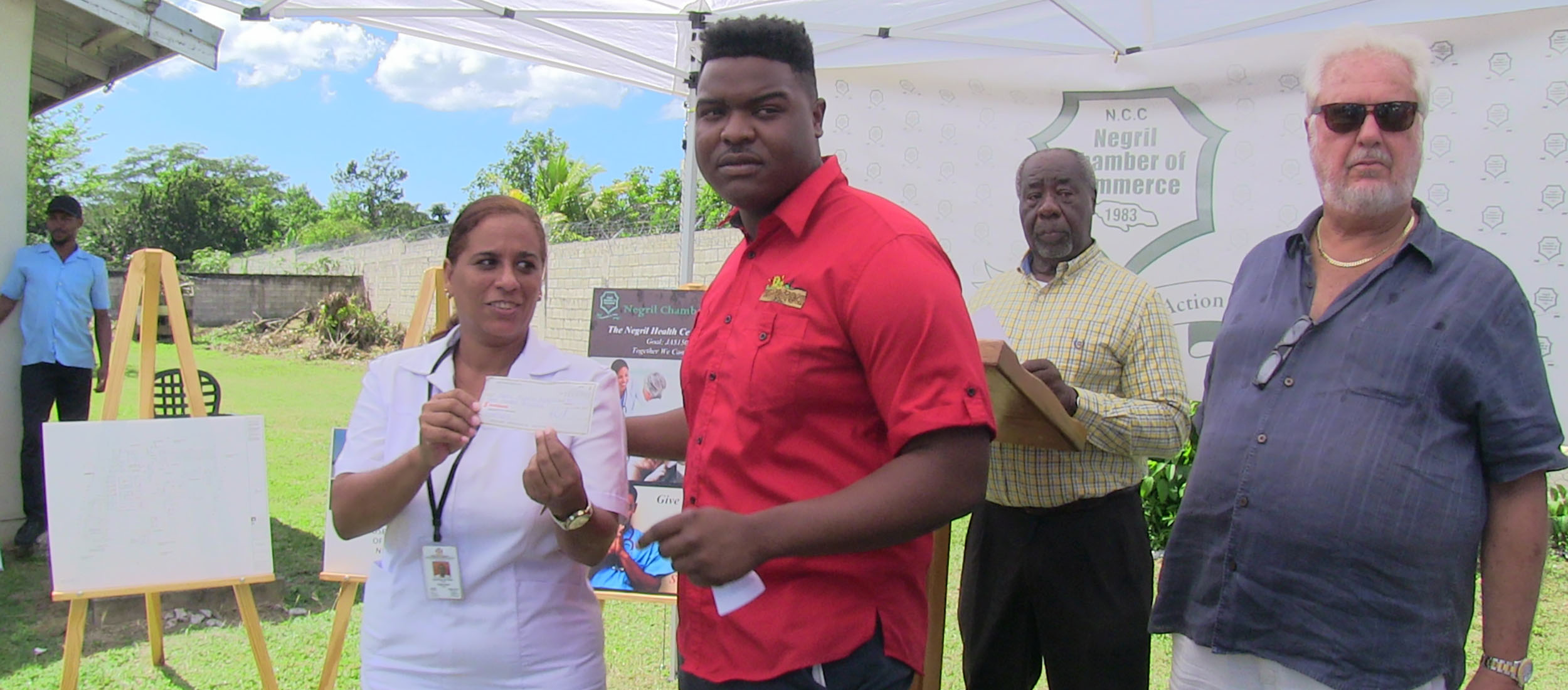Woodstock Negril presents $300,000.00 check to Negril Community Centre Fund
